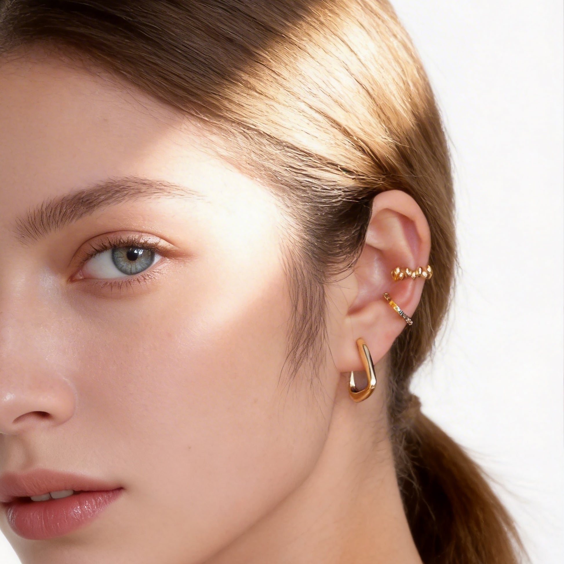 Polished Ribbed Clip-On Hoop Earrings in 18K gold plating by SOMIY for non-pierced ears.
