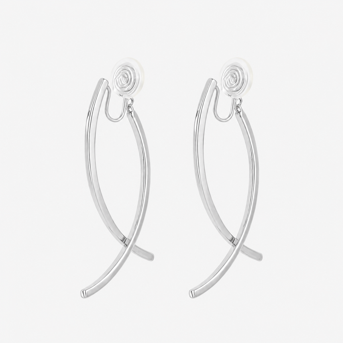 Silver curved dangle clip-on earrings with crossing polished arcs and cushioned coil backs, angled view