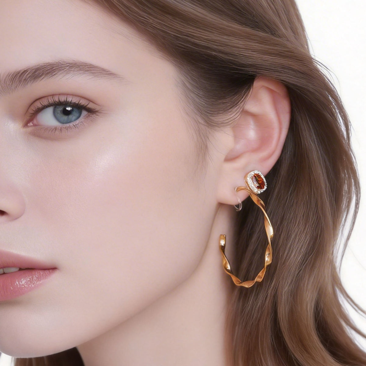 Profile showing a red halo stud worn with a separate gold hoop