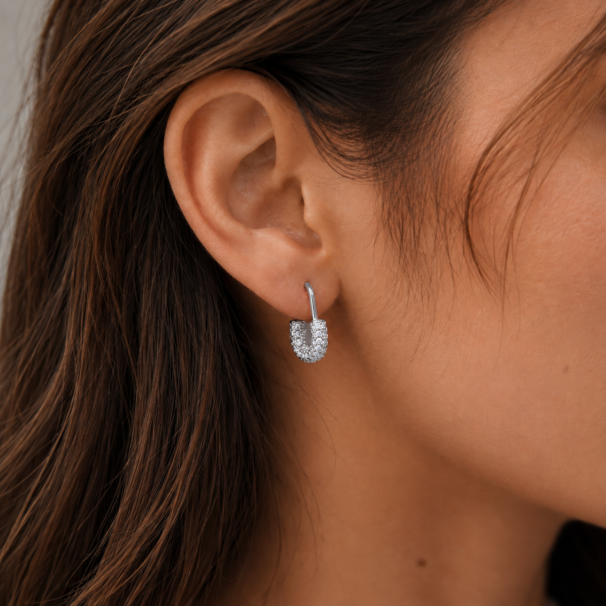 Close-up of SOMIY U-Shaped Pavé Clip-On Hoop Earrings in silver worn on the ear