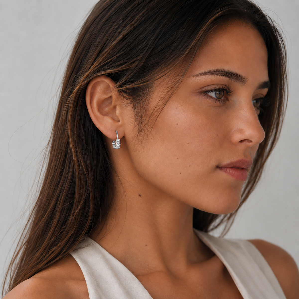 Model wearing SOMIY U-Shaped Pavé Clip-On Hoop Earrings in silver