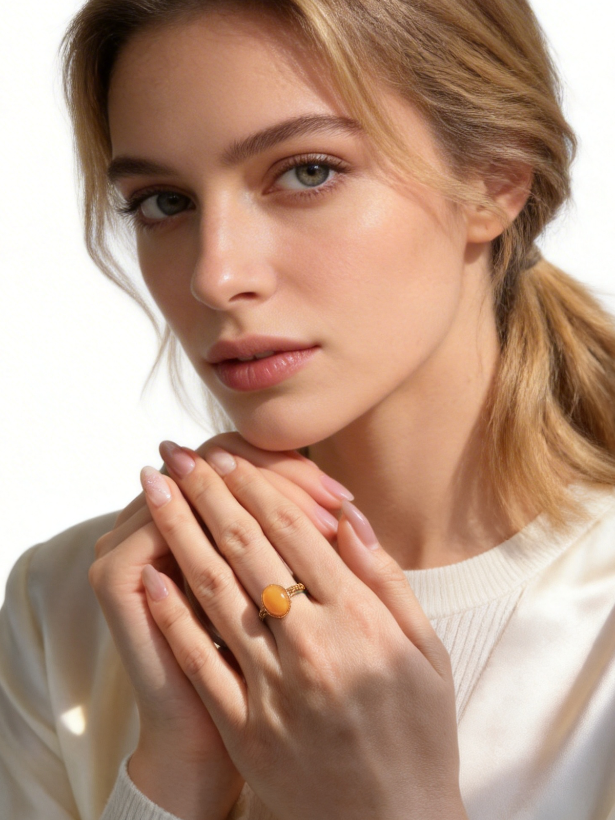 Model wearing the Verdant Vine amber ring with a soft ivory sweater