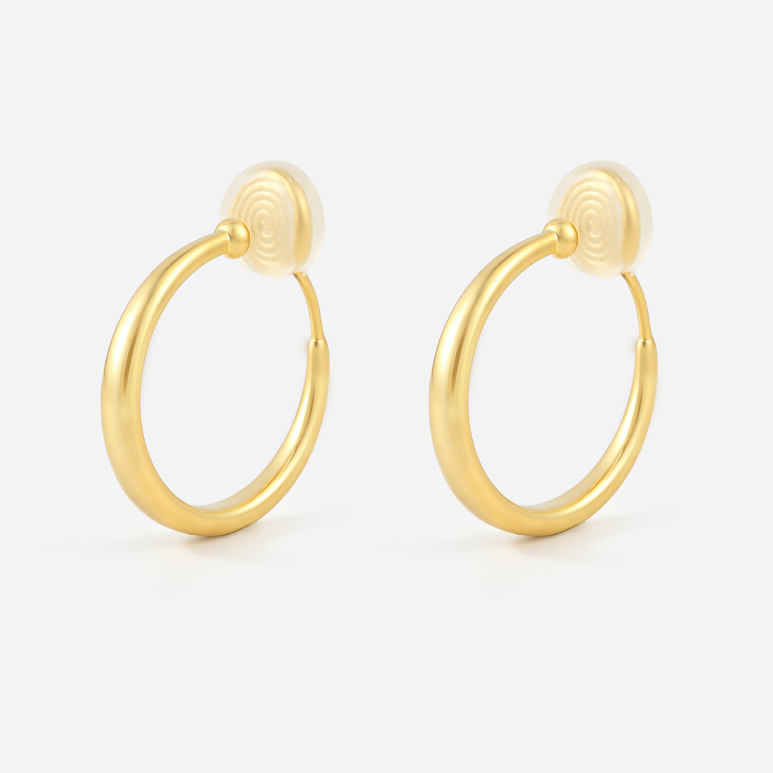 Gold matte hoop clip-on earrings with tapered curves and cushioned spiral backs, angled pair view