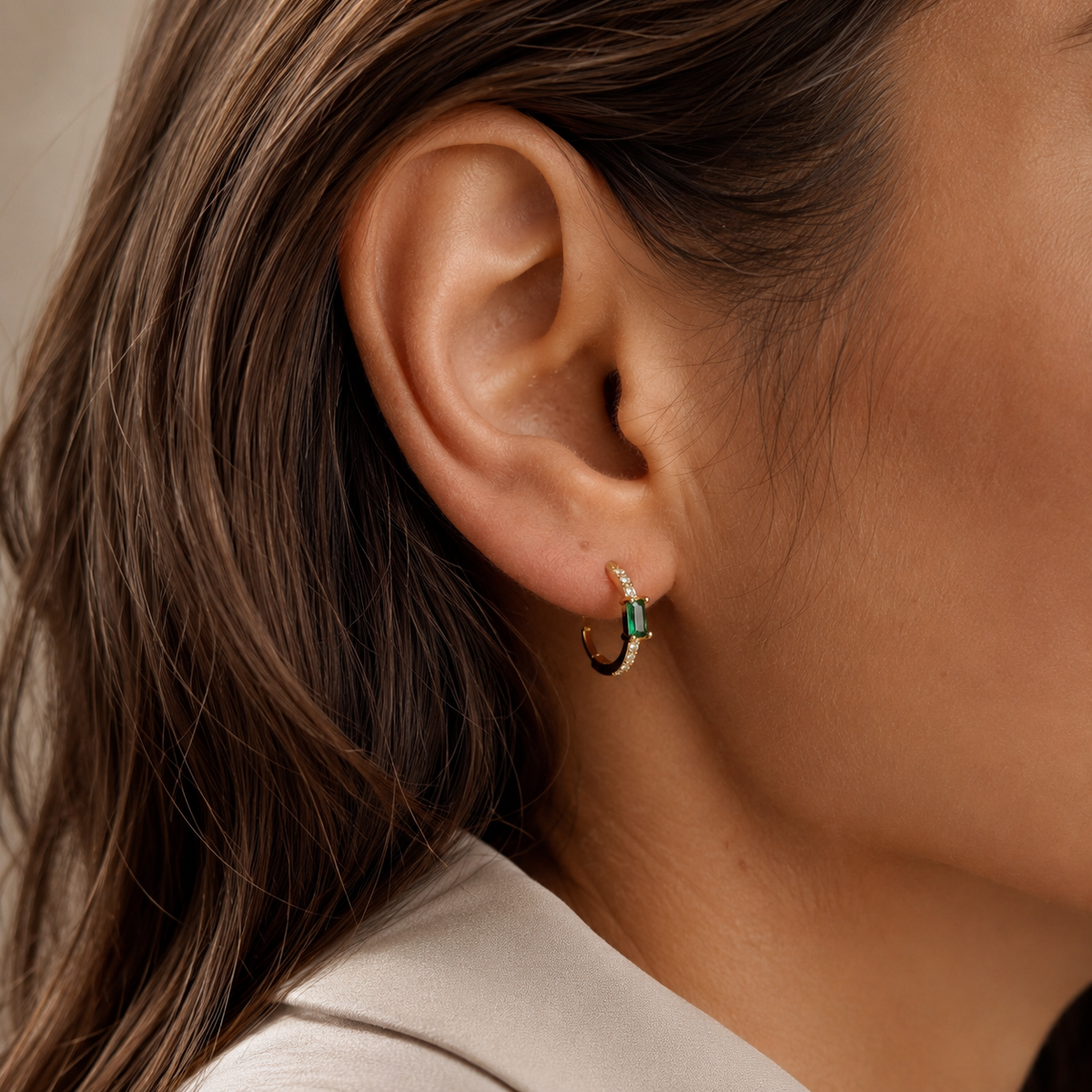 Close-up of SOMIY Green Gemstone Clip-On Hoop Earrings in gold worn on the ear