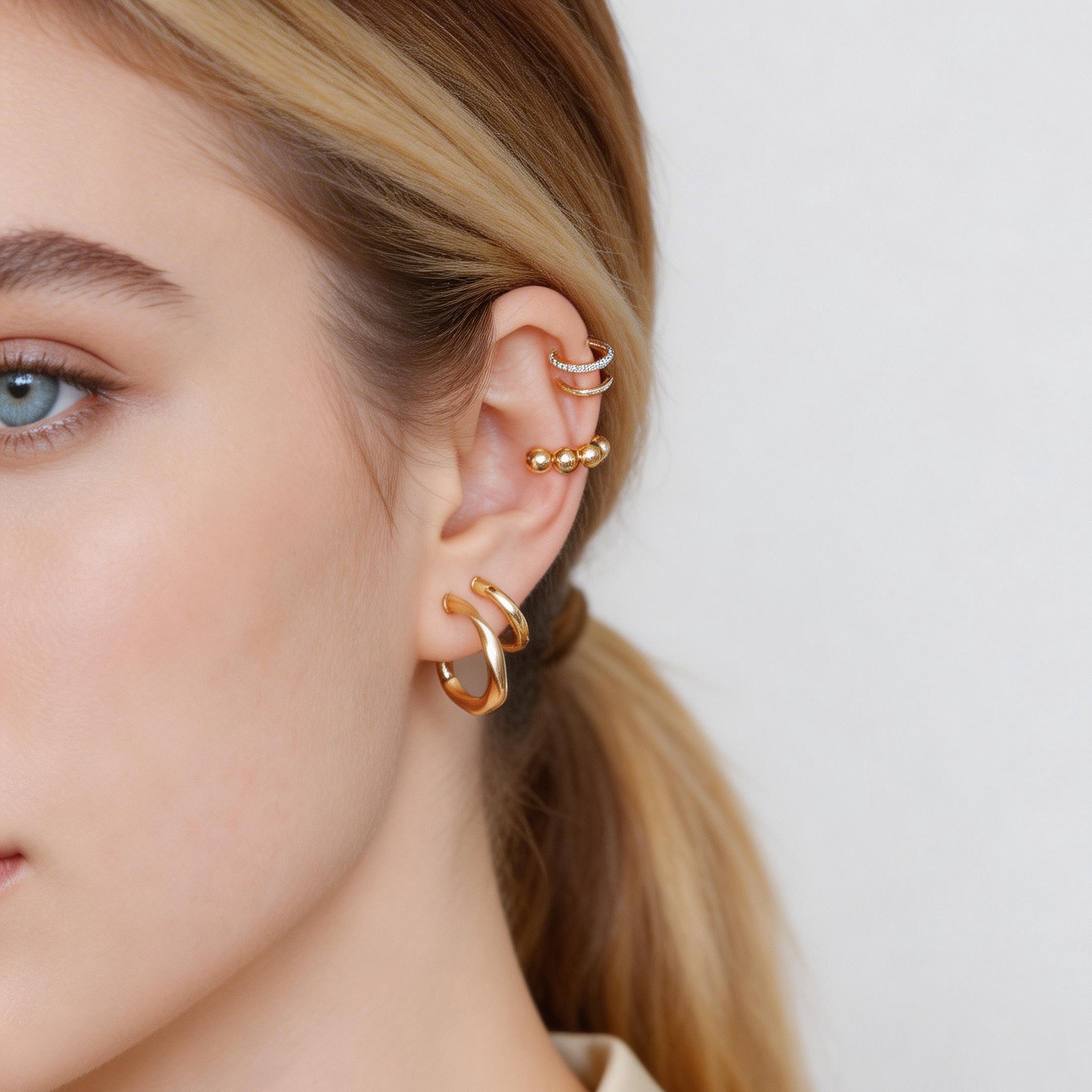 Sleek Linear Ridged Clip-On Hoop Earrings in 18K gold and silver by SOMIY for non-pierced ears.