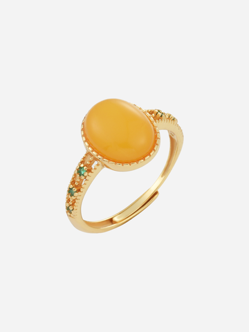 Verdant Vine butterscotch amber ring with an oval golden stone and green side accents
