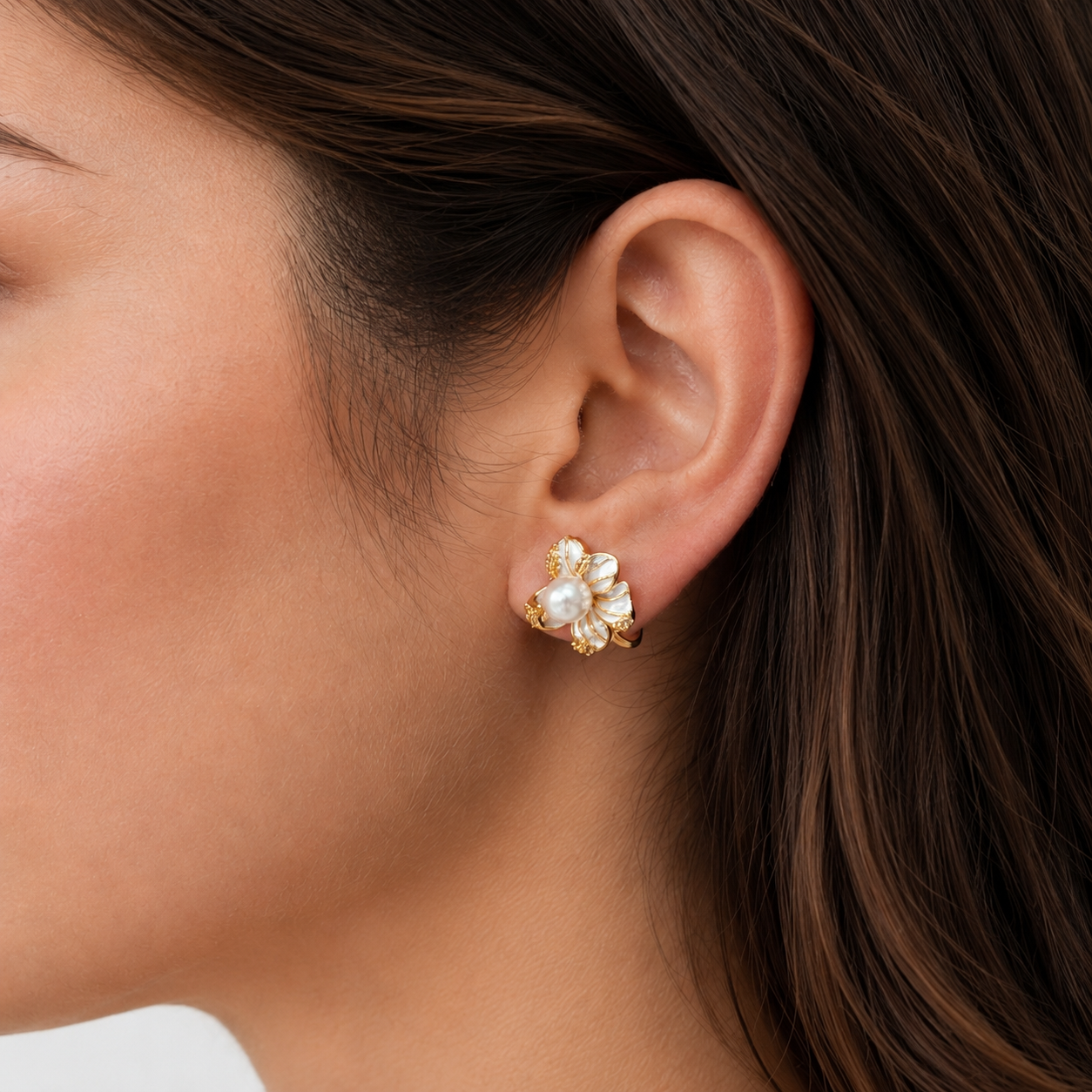 Close-up of Bloom Pearl Clip-On Stud Earrings in gold on model