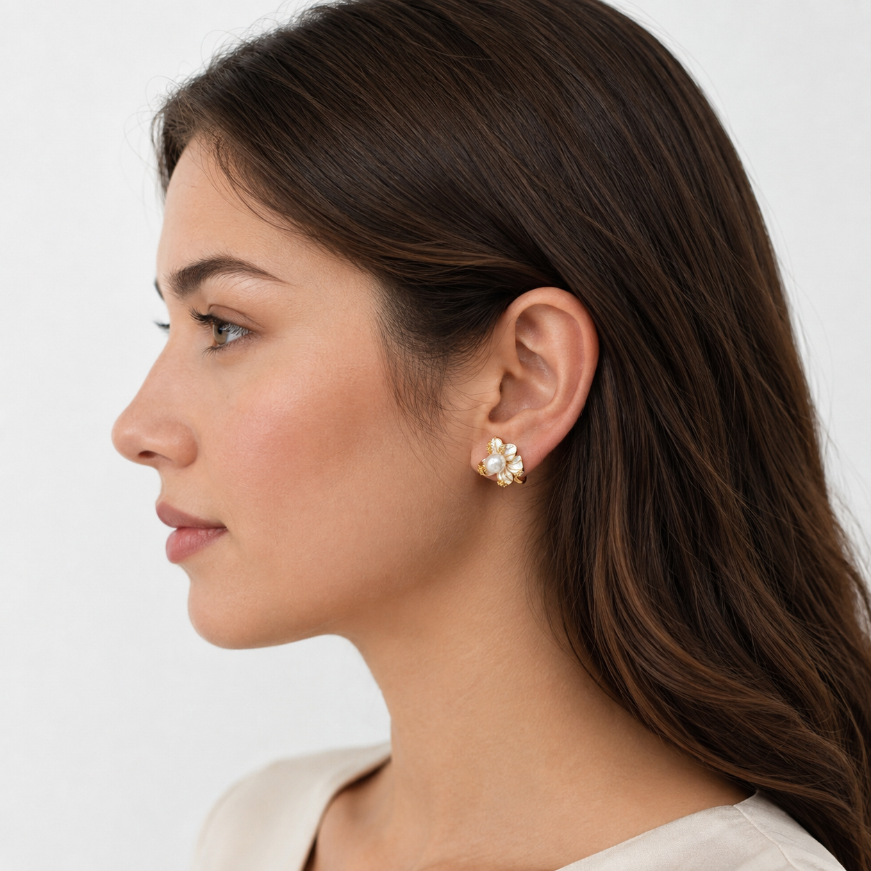 Model wearing Bloom Pearl Clip-On Stud Earrings in gold profile view