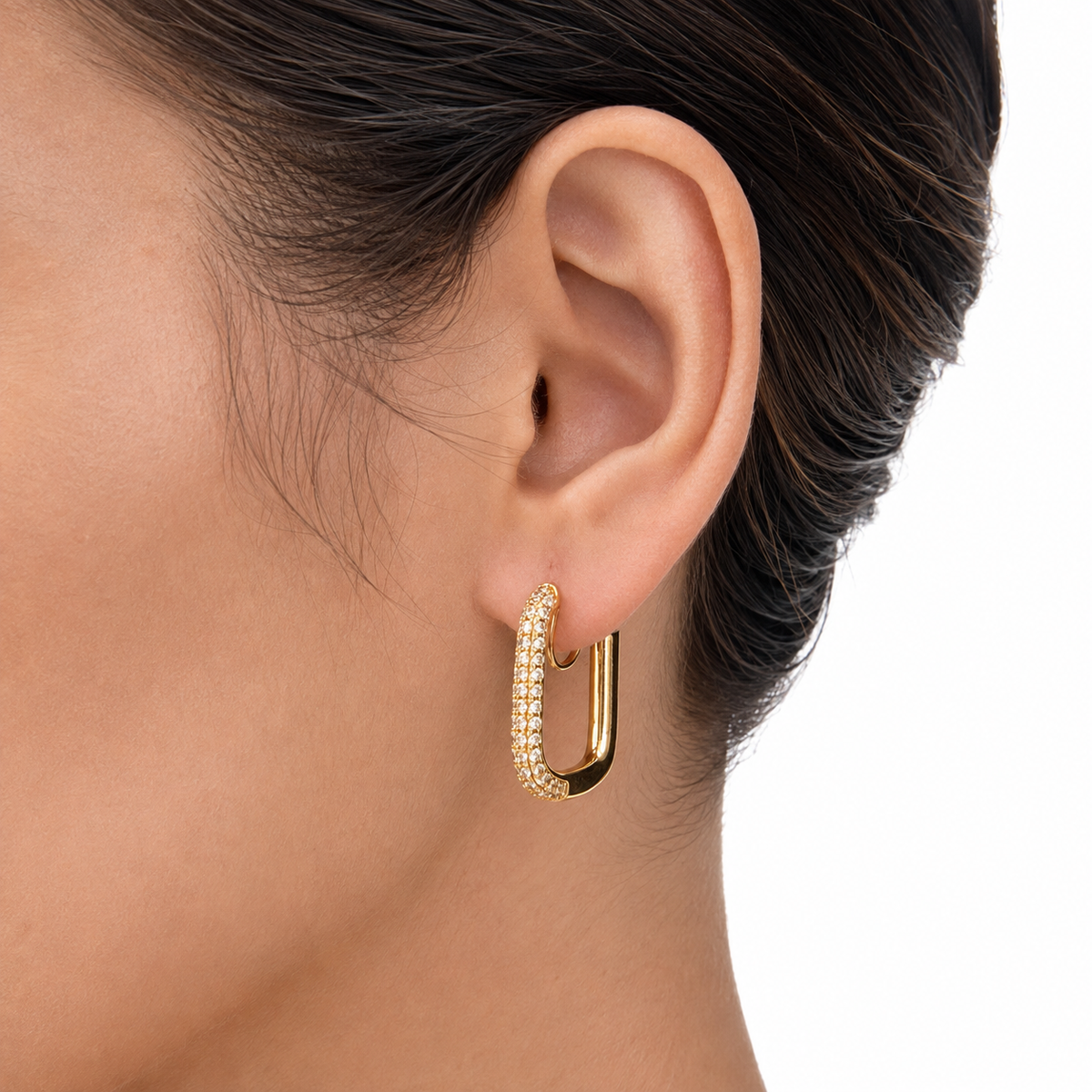 Close-up of a gold pavé rectangular clip-on hoop worn on the earlobe