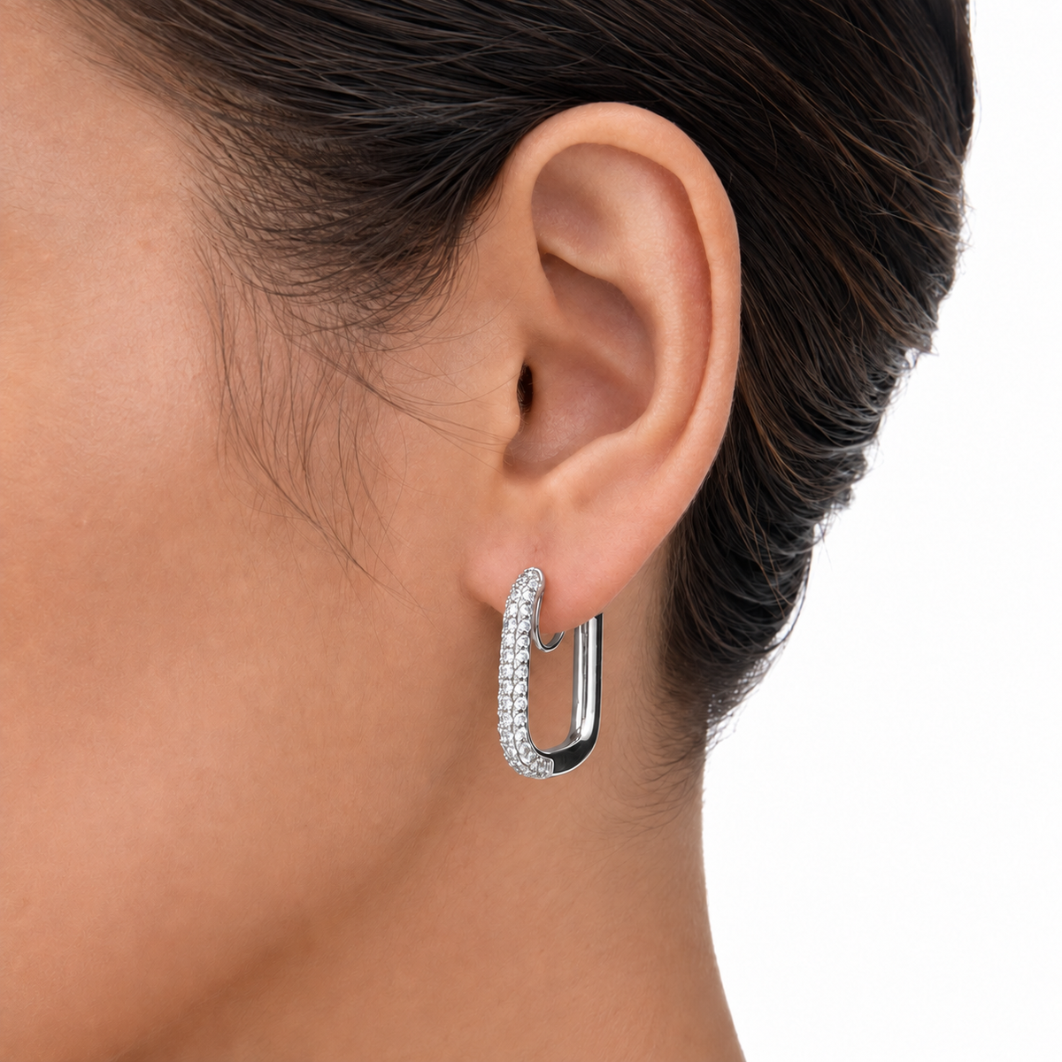 Close-up of a silver pavé rectangular clip-on hoop showing sparkling stones along the front