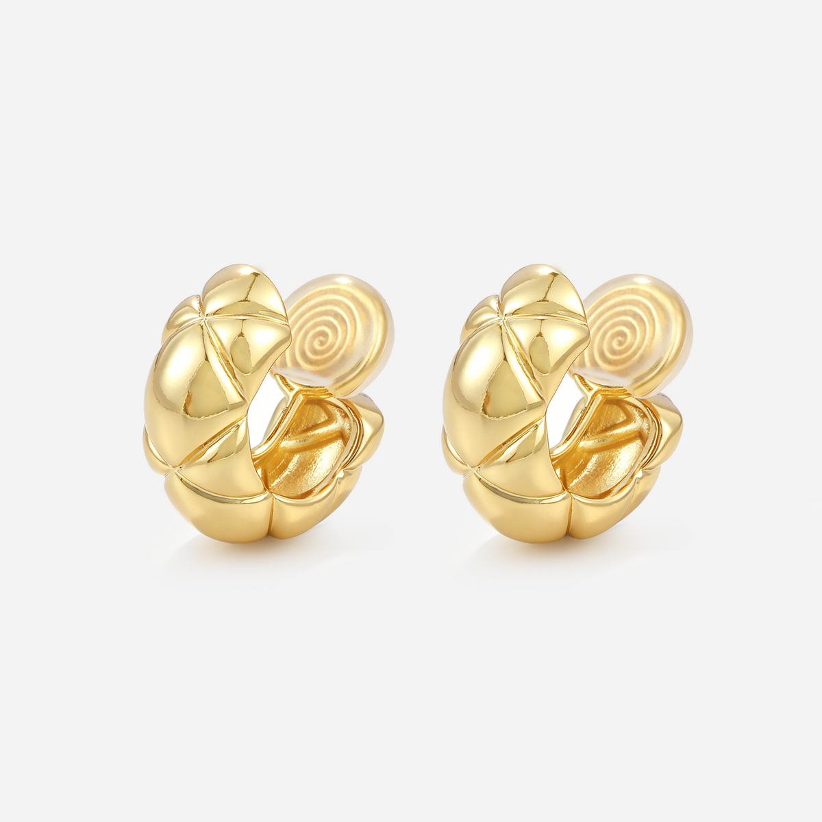 Gold quilted dome clip-on hoop earrings with polished raised sections and cushioned coil backs, angled view