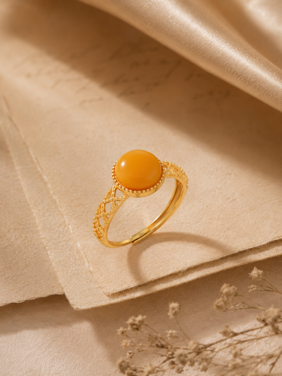 Lattice Filigree amber ring styled on beige stationery with dried flowers