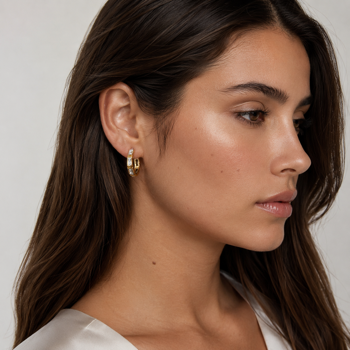 Model wearing SOMIY Bezel Baguette Clip-On Hoop Earrings in gold