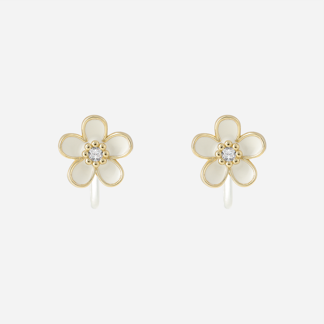 Angled view of gold-finish white enamel flower studs with transparent resin clips