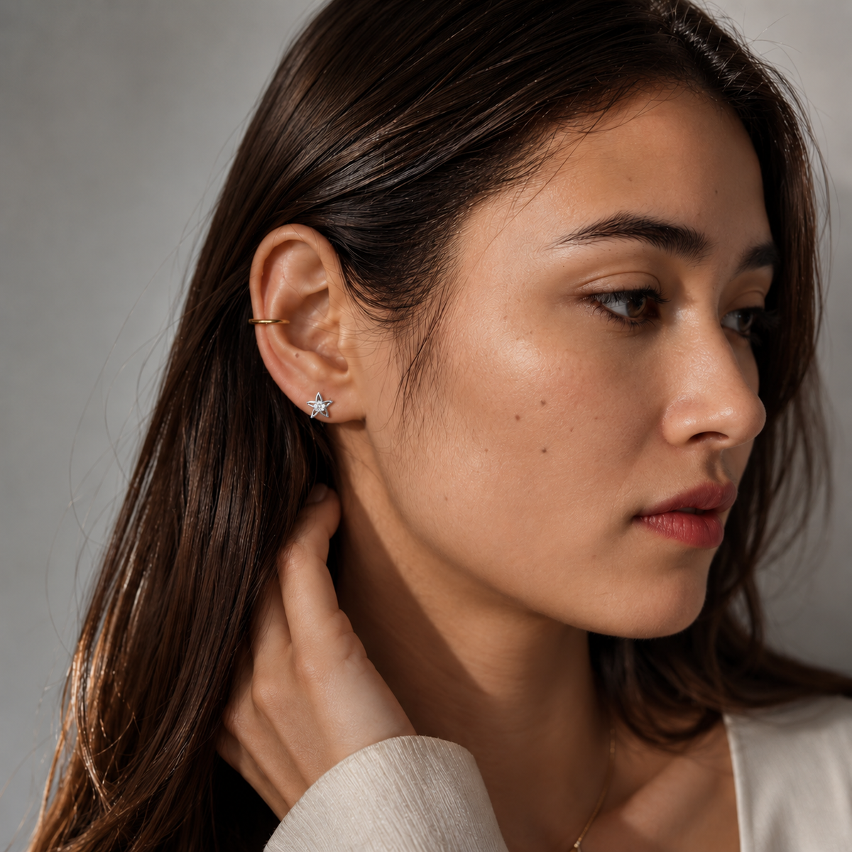 Model wearing SOMIY Mini Star CZ Clip-On Stud Earrings in silver