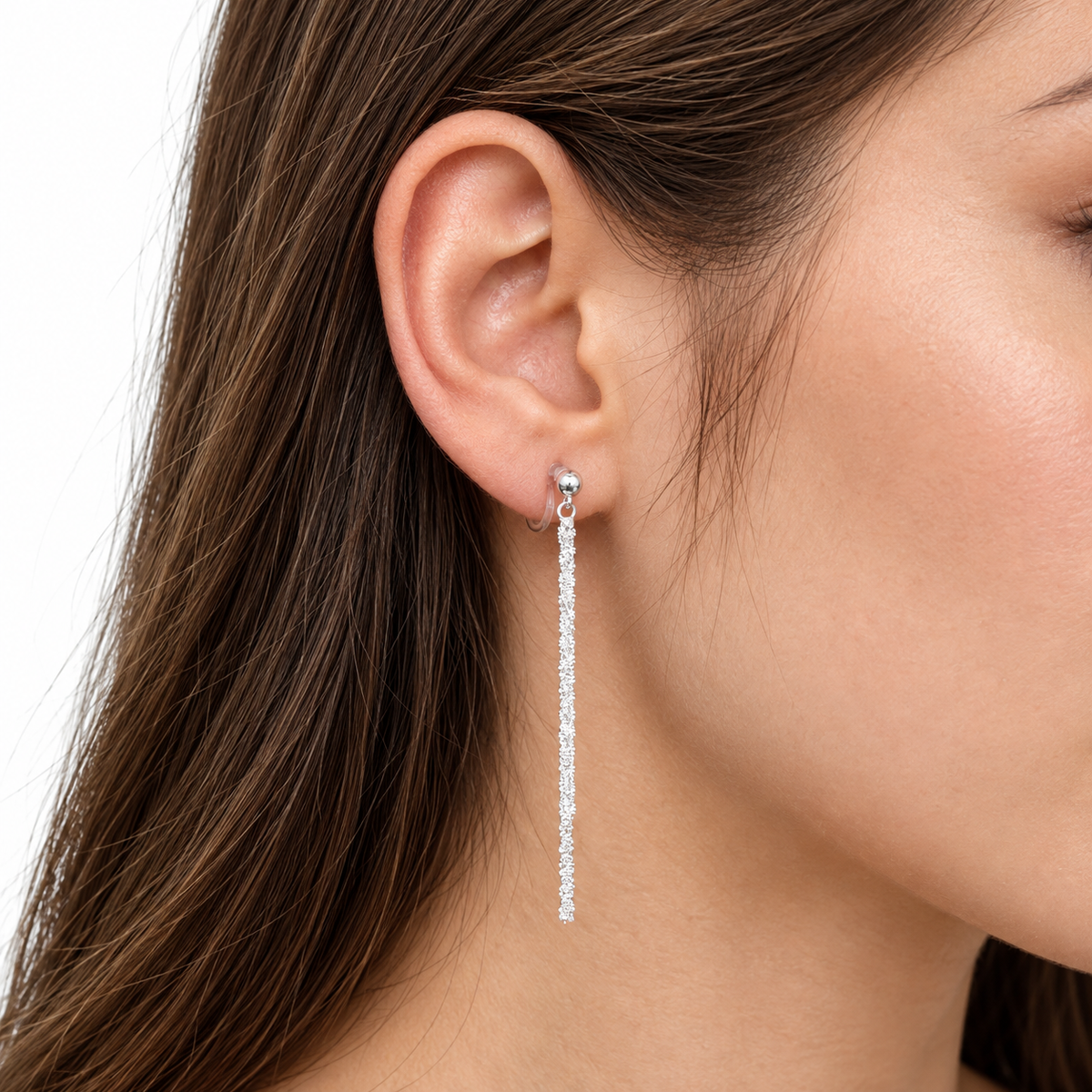 Close-up of SOMIY Round Top Chain Tassel Clip-On Dangle Earrings in silver worn on the ear