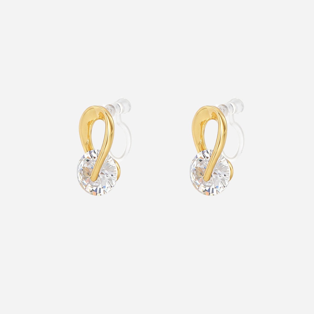 Angled view of SOMIY Solitaire Loop Clip-On Stud Earrings in gold, showing the clear resin clips
