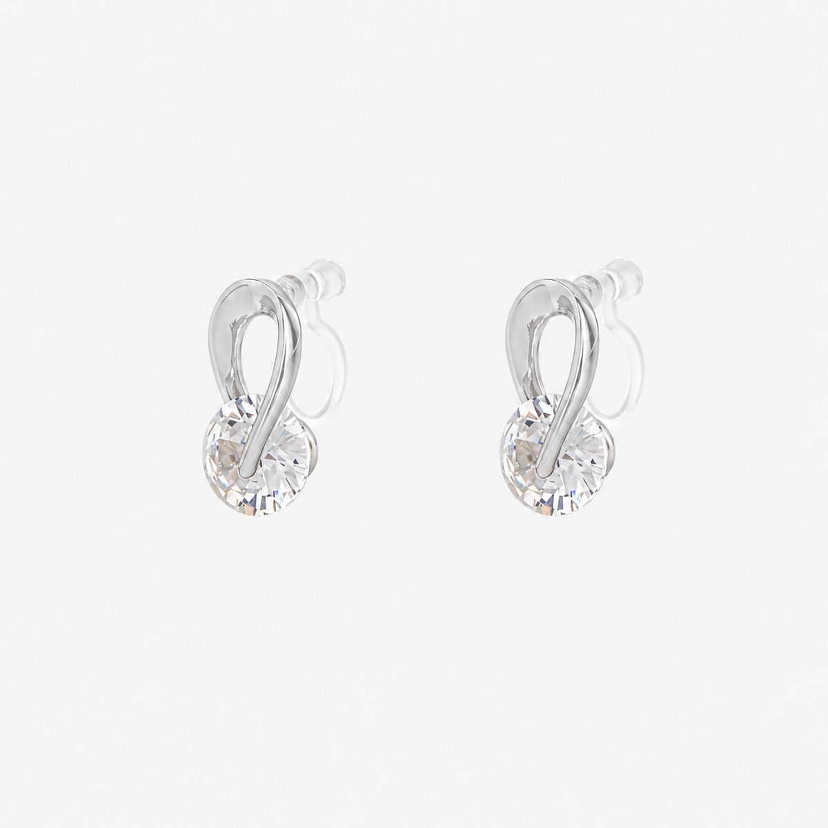 Angled view of SOMIY Solitaire Loop Clip-On Stud Earrings in silver, showing the clear resin clips