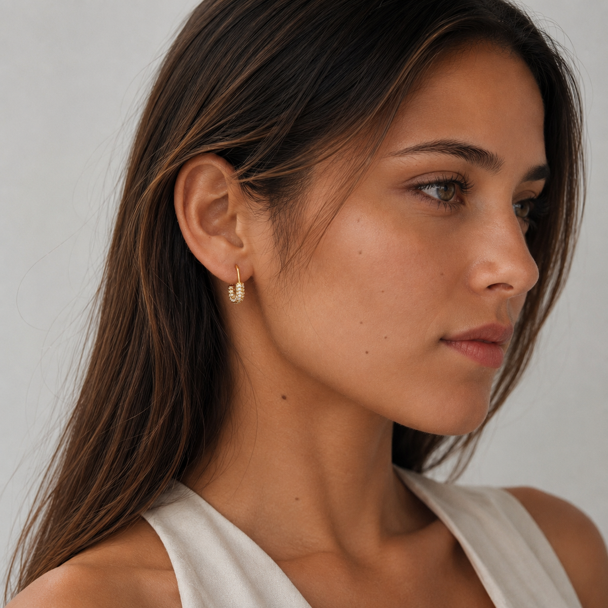 Model wearing SOMIY U-Shaped Pavé Clip-On Hoop Earrings in gold