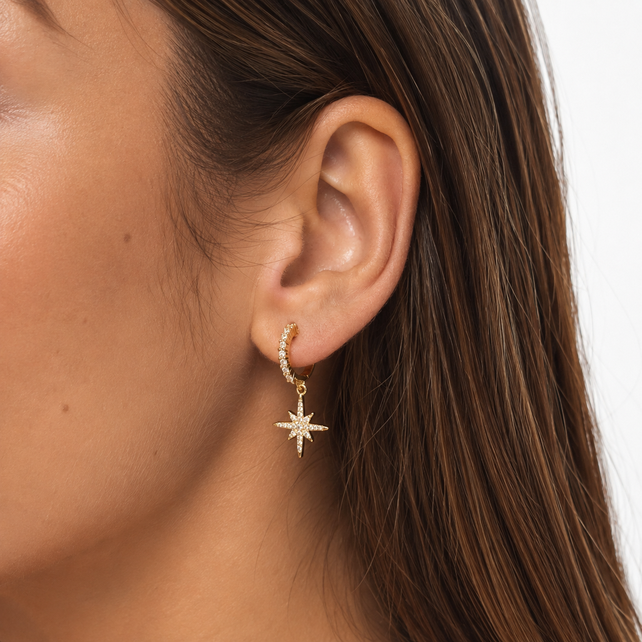 Model wearing Starburst Crystal Clip-On Dangle Earrings in gold close-up view