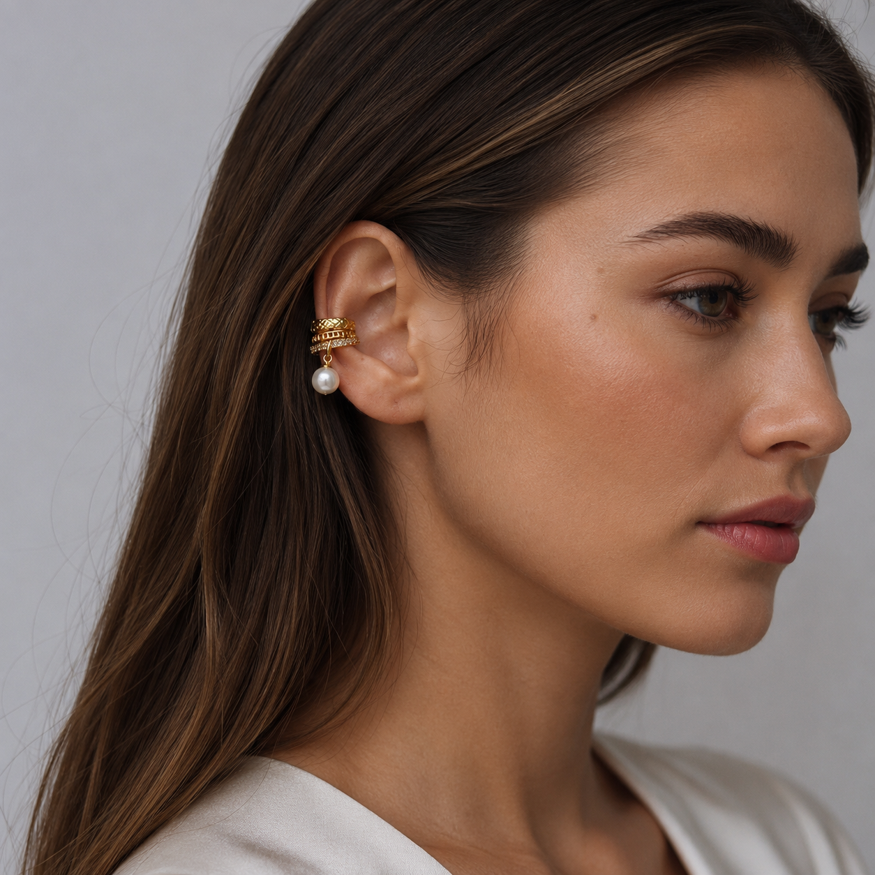 Gold pearl drop ear cuff worn by model
