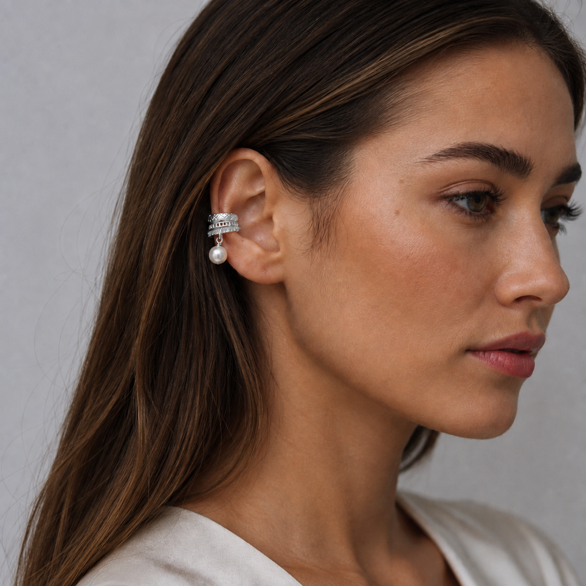 Silver pearl drop ear cuff worn by model